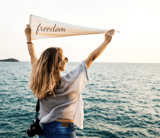 Womna holding banner with word Freedom