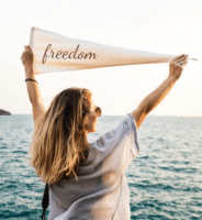 Woman holding banner with word freedom. Aign with values to lighten mental load.