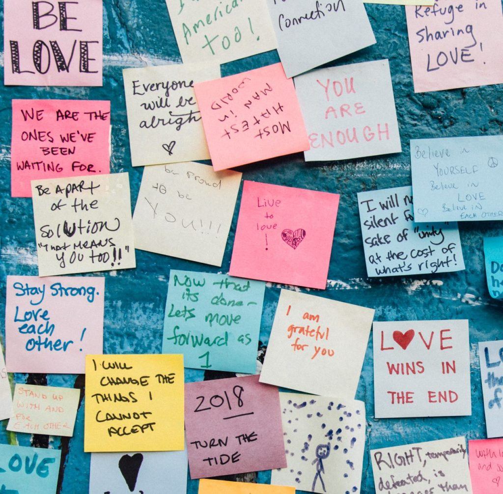 Wall of sticky notes about love, courage, being enough