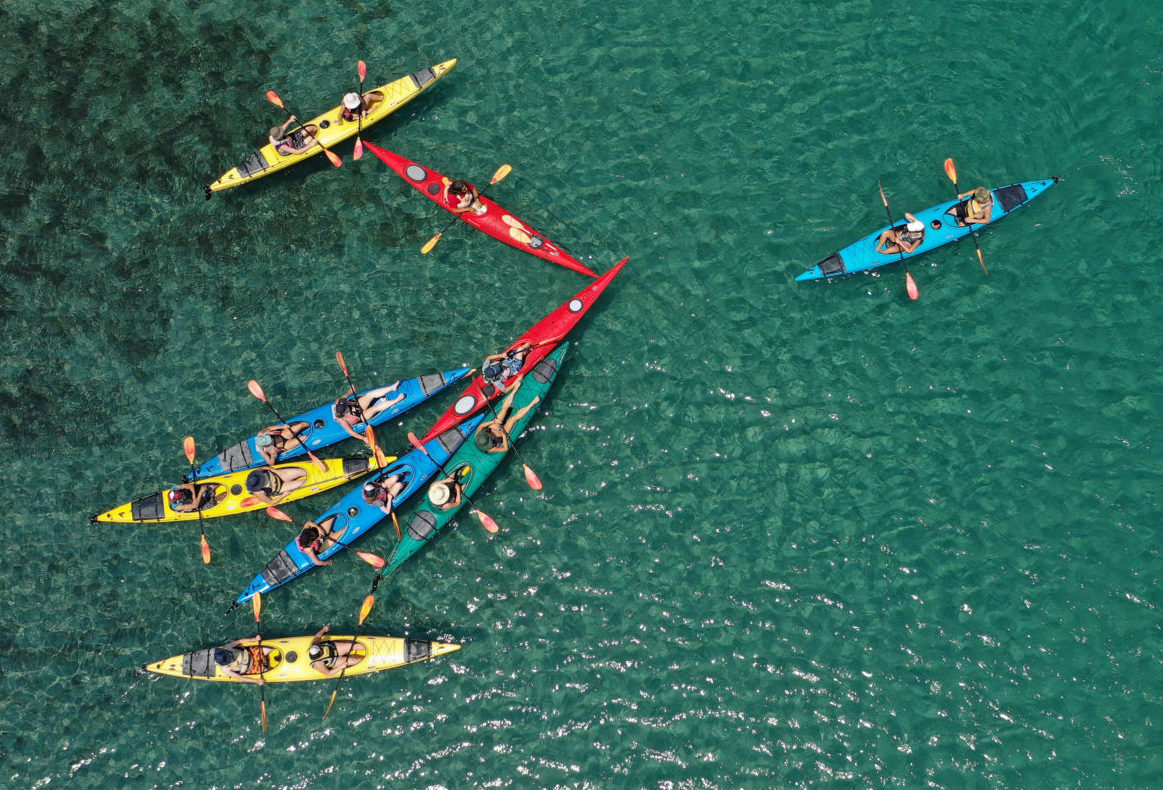 Aerial drone ultra wide photo of young couple canoeing in tropical ...